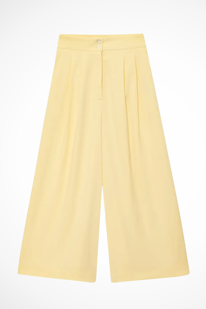 Summer-ready women's outfit: a stylish sleeveless wrap top and breezy wide leg trousers suit set.