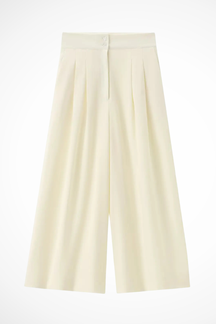 Chic women's high-waist wide leg trousers paired with a sophisticated sleeveless wrap top ensemble.