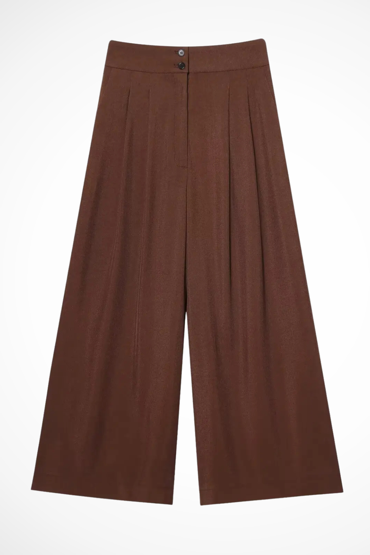 Modern women's suit set: sleeveless wrap top & wide leg trousers for an effortlessly chic elegant outfit.