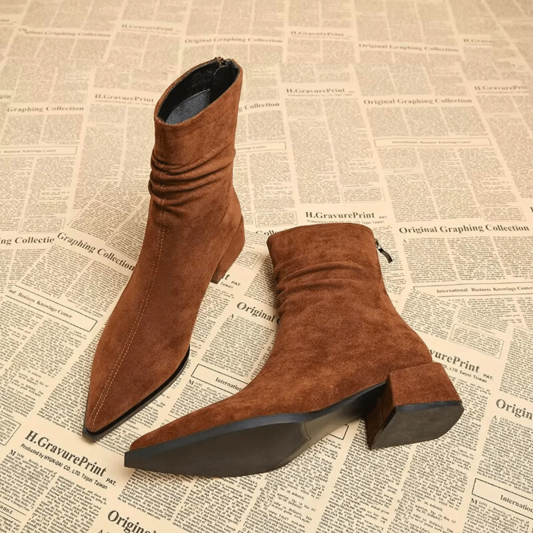 Elegant black slouchy ankle boots for women. Features a sharp pointed toe & comfortable block heel. Winter style.