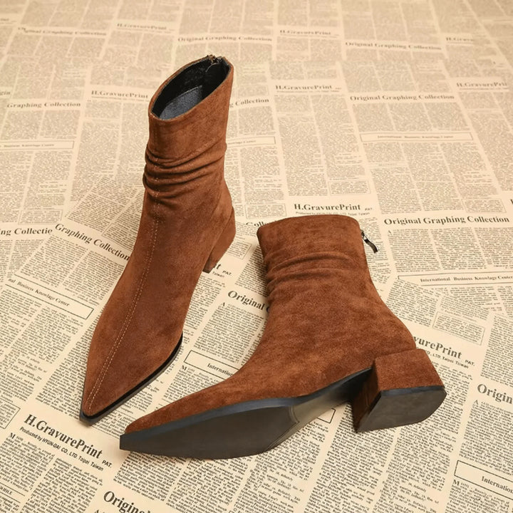 Elegant black slouchy ankle boots for women. Features a sharp pointed toe & comfortable block heel. Winter style.