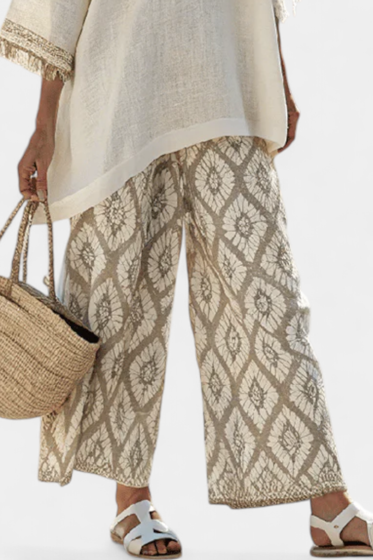 Women's casual chic striped blouse and wide-leg trousers set. Stylish summer two-piece outfit for comfort.