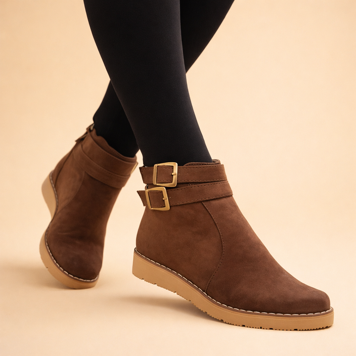 Fashionable women's blue structured ankle boots featuring double buckles, a must-have for winter fashion.