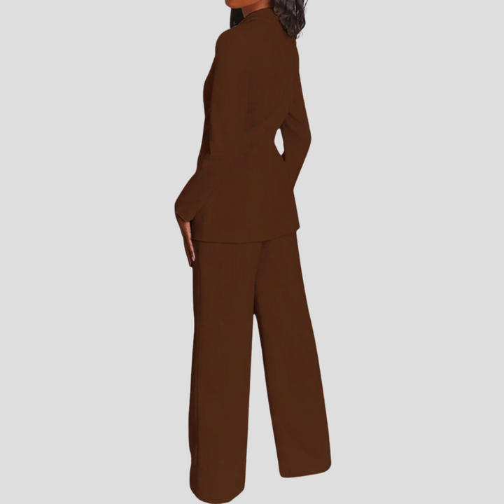 Side profile of a woman in a tailored trouser suit, emphasizing its modern cut.