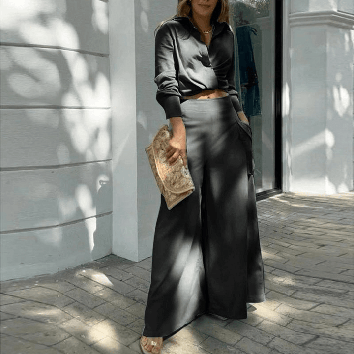 Modern women's two-piece set featuring a chic crop top and flowy wide-leg trousers. Versatile fashion.