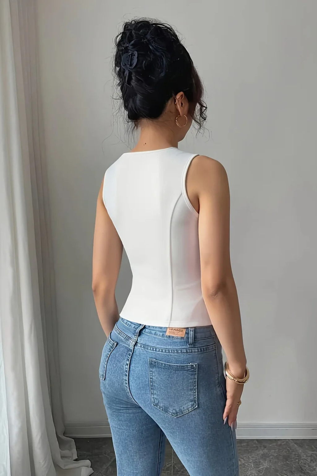 Fitted women's V-neck summer vest with tailored design & chic metal buckle. Perfect elegant fashion statement.