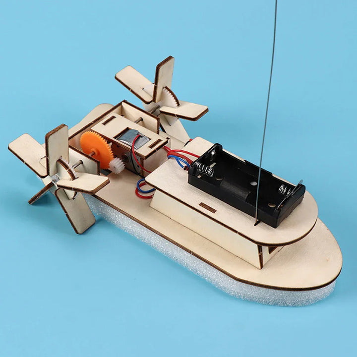 Close-up of wooden pieces for children's educational DIY electric toy boat kit.