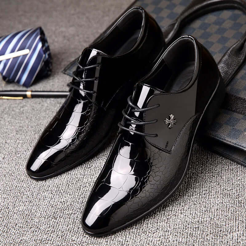Detailed view of men's black lace-up oxford shoes. Classic formal footwear for sophisticated business and wedding styles.