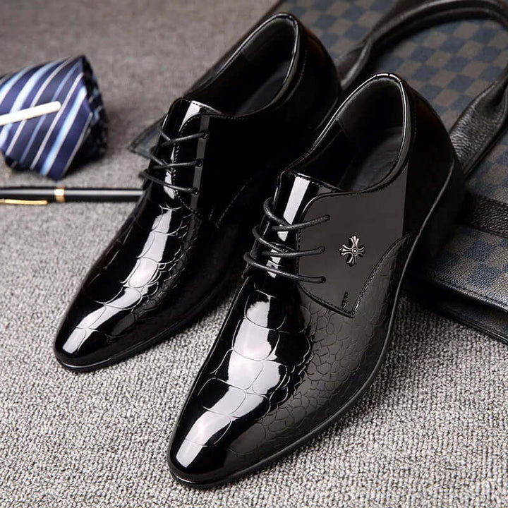 Detailed view of men's black lace-up oxford shoes. Classic formal footwear for sophisticated business and wedding styles.