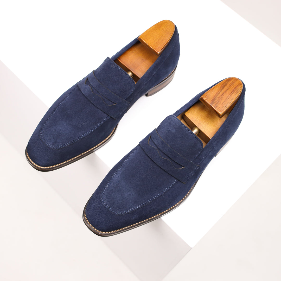 Classic black men's slip-on penny loafers, ideal for smart casual or dress wear. Comfortable & versatile men's shoes.
