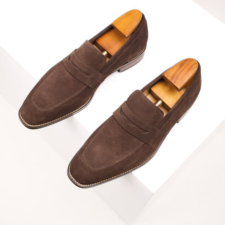 Stylish dark blue men's slip-on penny loafers with classic design, perfect for effortless smart casual and formal looks.