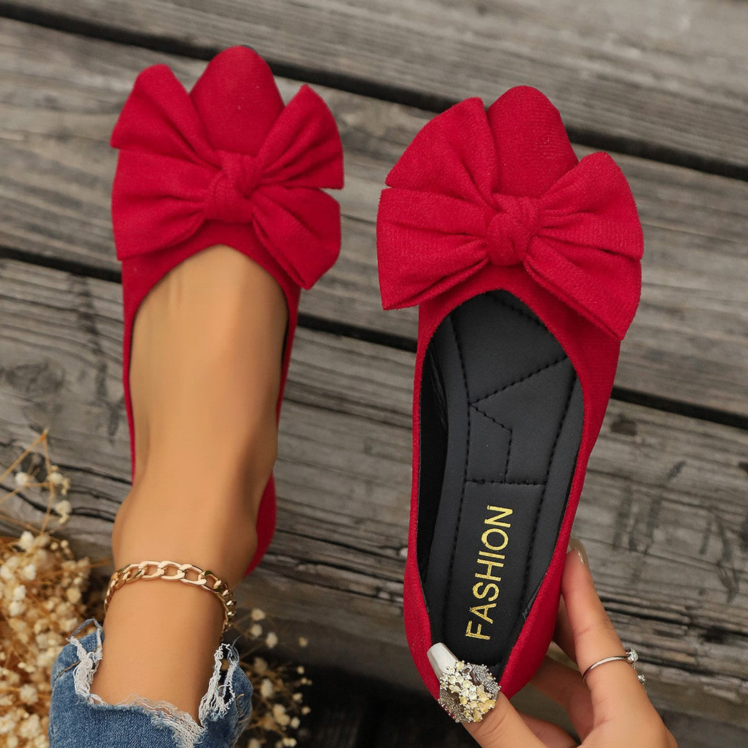 Versatile dark blue women's ballet flats with a cute bow detail, great for casual outings or office.