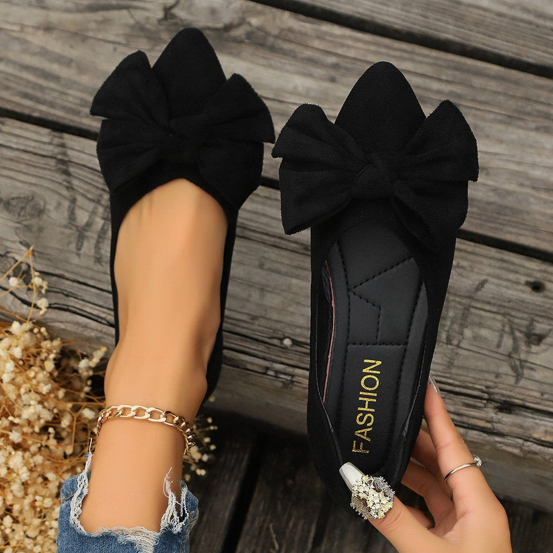 Elegant beige women's ballet flats with bow, designed for comfortable office wear and smart casual outfits.