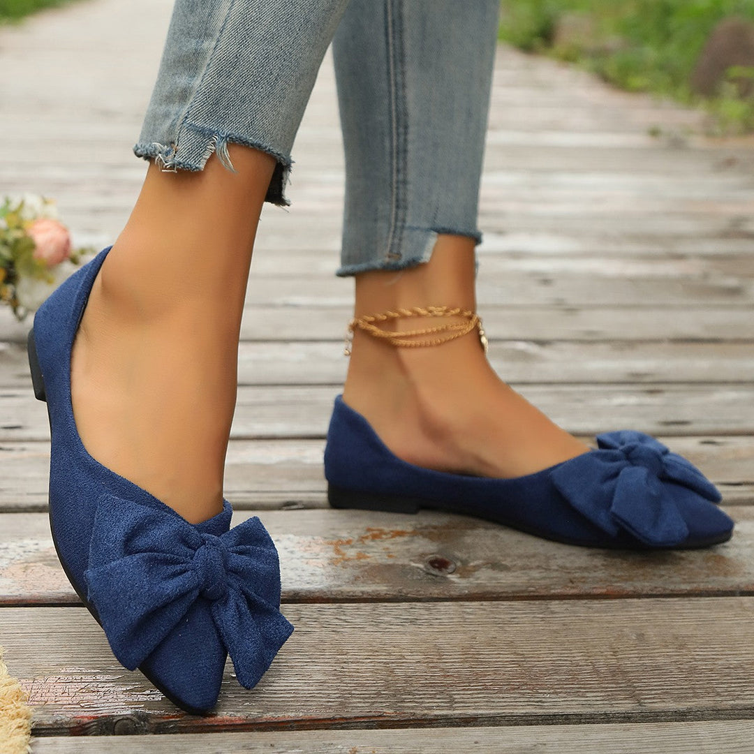 Collection of women's bow detail ballet flats in various colors: black, red, and beige for versatile styling.