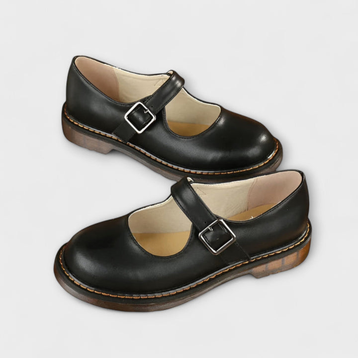 Classic black women's Mary Jane shoes with buckle, flat and comfortable for elegant everyday wear.
