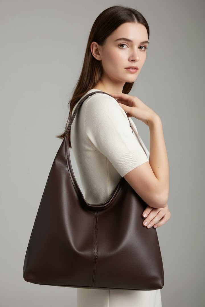 Elegant faux leather shoulder tote bag for women, featuring a large internal pocket.