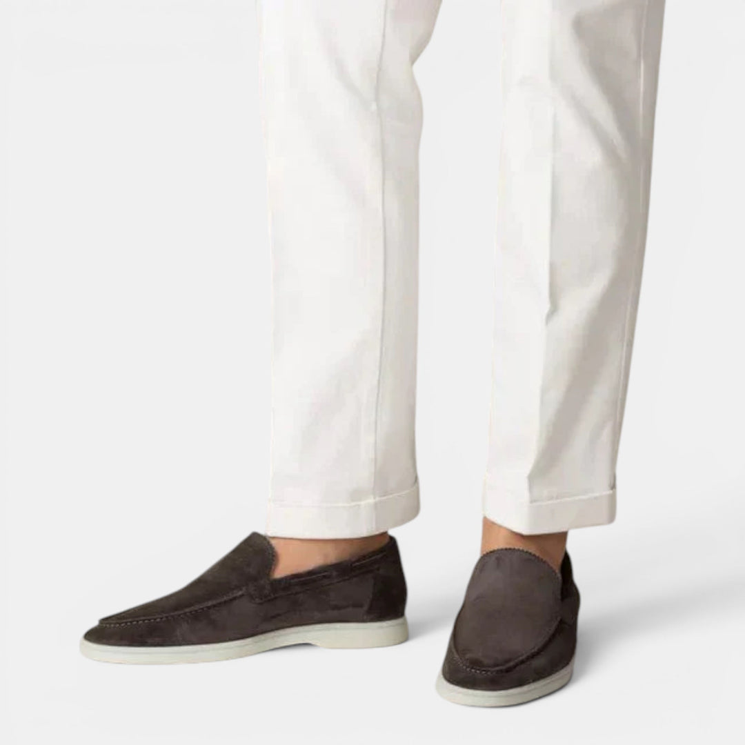 Men's slip-on loafers with a minimalist design, emphasizing sleek style & comfortable wear.