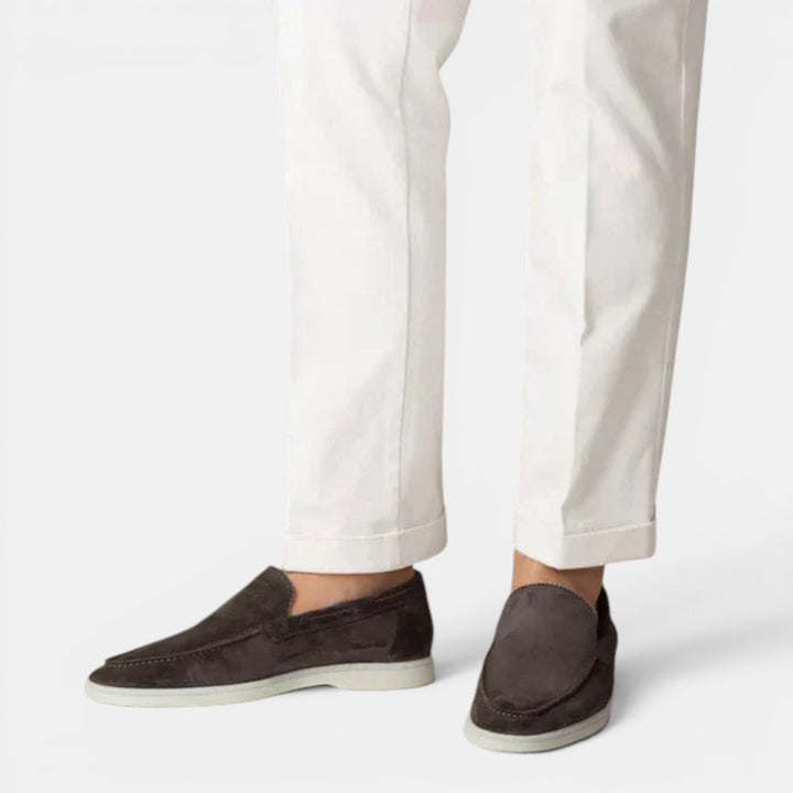 Men's slip-on loafers with a minimalist design, emphasizing sleek style & comfortable wear.