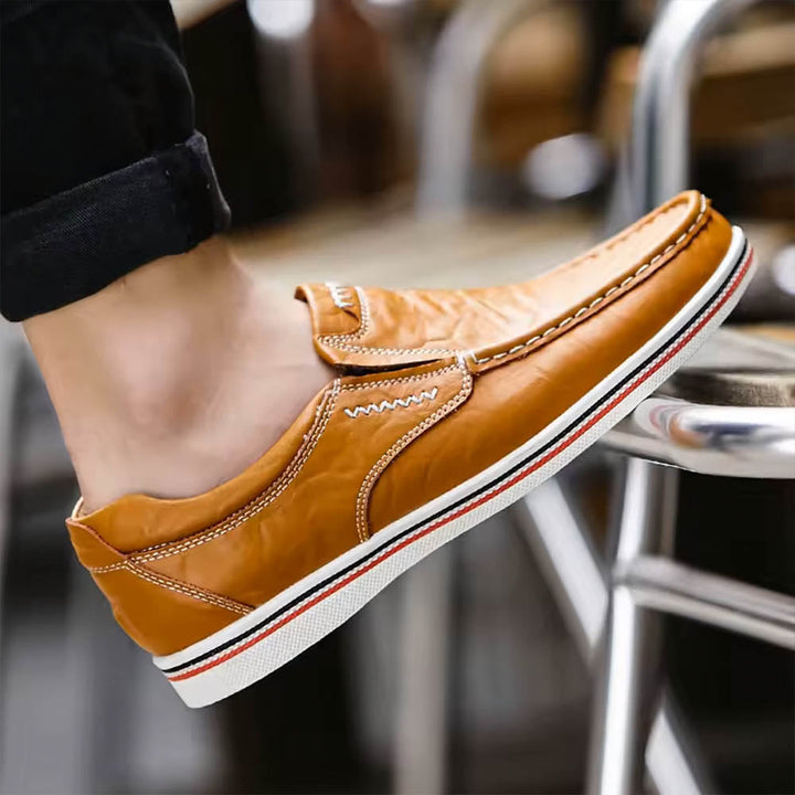 Classic men's slip-on loafers in black leather, perfect for elegant formal or comfortable casual everyday style.