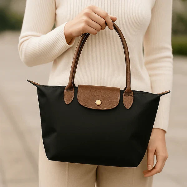 Stylish women's structured shoulder bag with a two-tone leather-look finish. This classic handbag offers everyday elegance.
