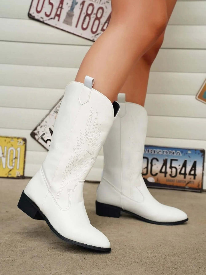 Black women's western boots with intricate stitching, comfortable & trendy.