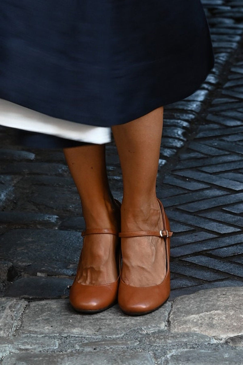 Women's classic Mary Jane shoes featuring a stylish block heel, rounded toe, and secure buckle strap. Elegant & comfy.