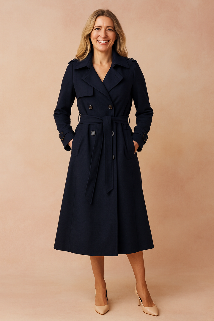 Fashionable women's outerwear: a long, classic trench coat with buckle closure.