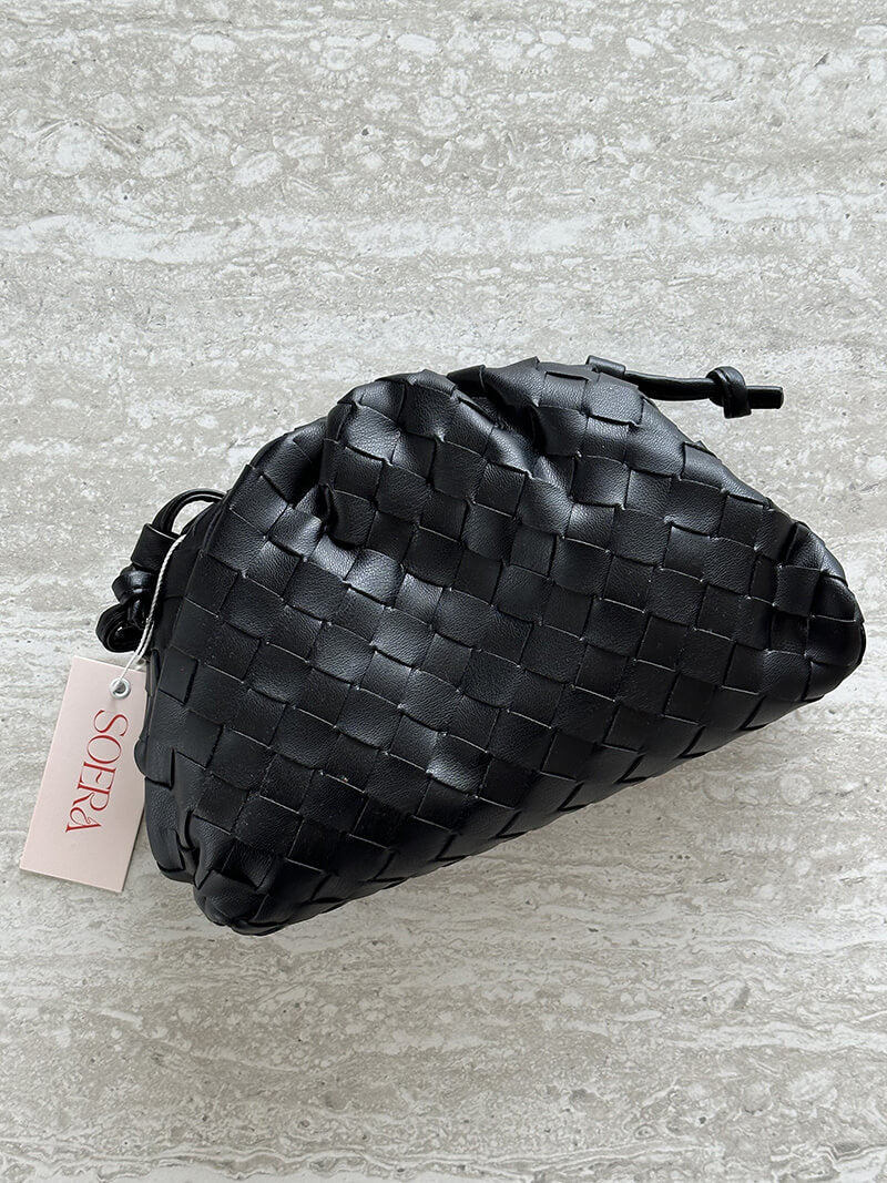 Side profile of a chic women's woven shoulder bag, showcasing its sleek design and high-quality finish.