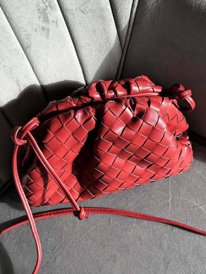 A close-up of the textured woven pattern on a fashionable women's shoulder bag, highlighting quality.