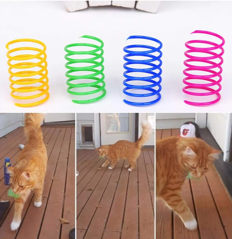 Close-up of colorful spring cat toys with feathers. Engaging pet supplies for kitten playtime.