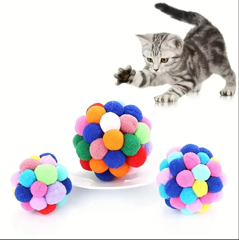 Assortment of colourful pompom cat balls, lightweight interactive toys promoting active feline playtime.
