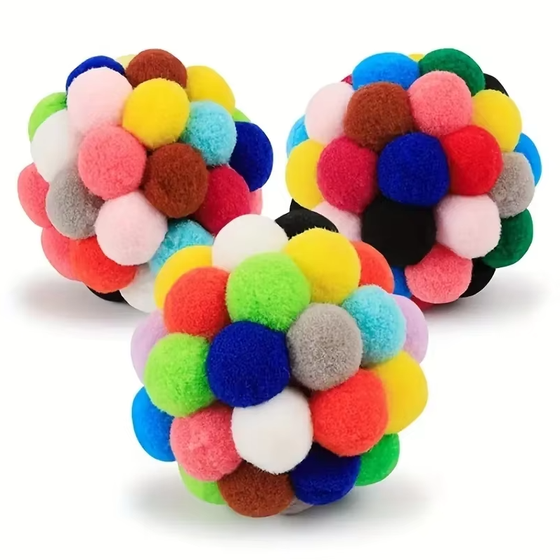 Brightly hued pompom cat toy, an engaging soft ball designed for interactive fun & pet enrichment.