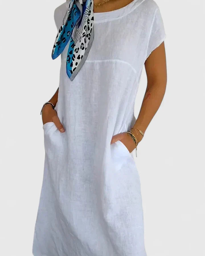 Stylish short-sleeve A-line midi dress for women, featuring convenient pockets and a relaxed fit.