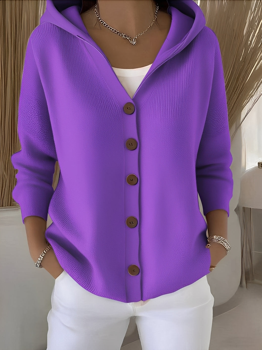 Stylish women's button-front hooded cardigan, offering a relaxed fit for comfortable casual wear.