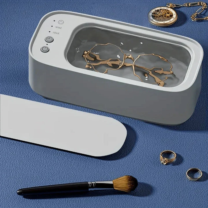 High-tech ultrasonic cleaner deeply cleaning a metal watch strap. Ensures hygiene for watches, jewelry & glasses.