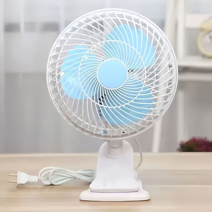Close-up of a white portable desk fan's safety grille and quiet blades, ensuring personal cooling.