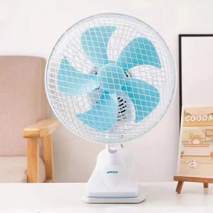 Portable desk fan positioned on a clean desk, providing quiet cooling for a productive workspace.