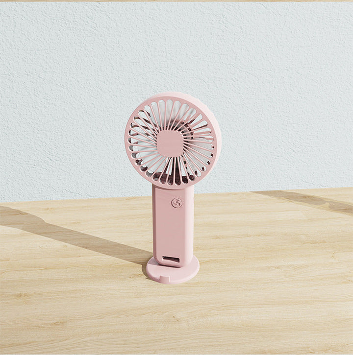 Small portable rechargeable fan, versatile for desk, travel, or hands-free personal cooling.