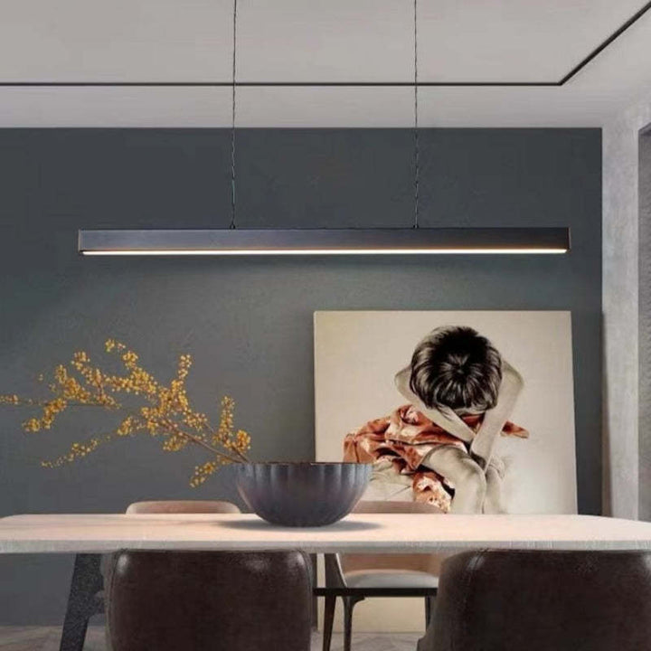 Modern LED linear pendant light in black, ideal for kitchen island task lighting.