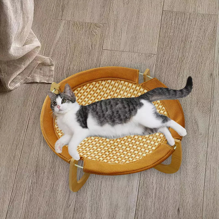 Cooling rattan hanging cat bed for summer. Breathable elevated pet hammock, perfect for cat relaxation.