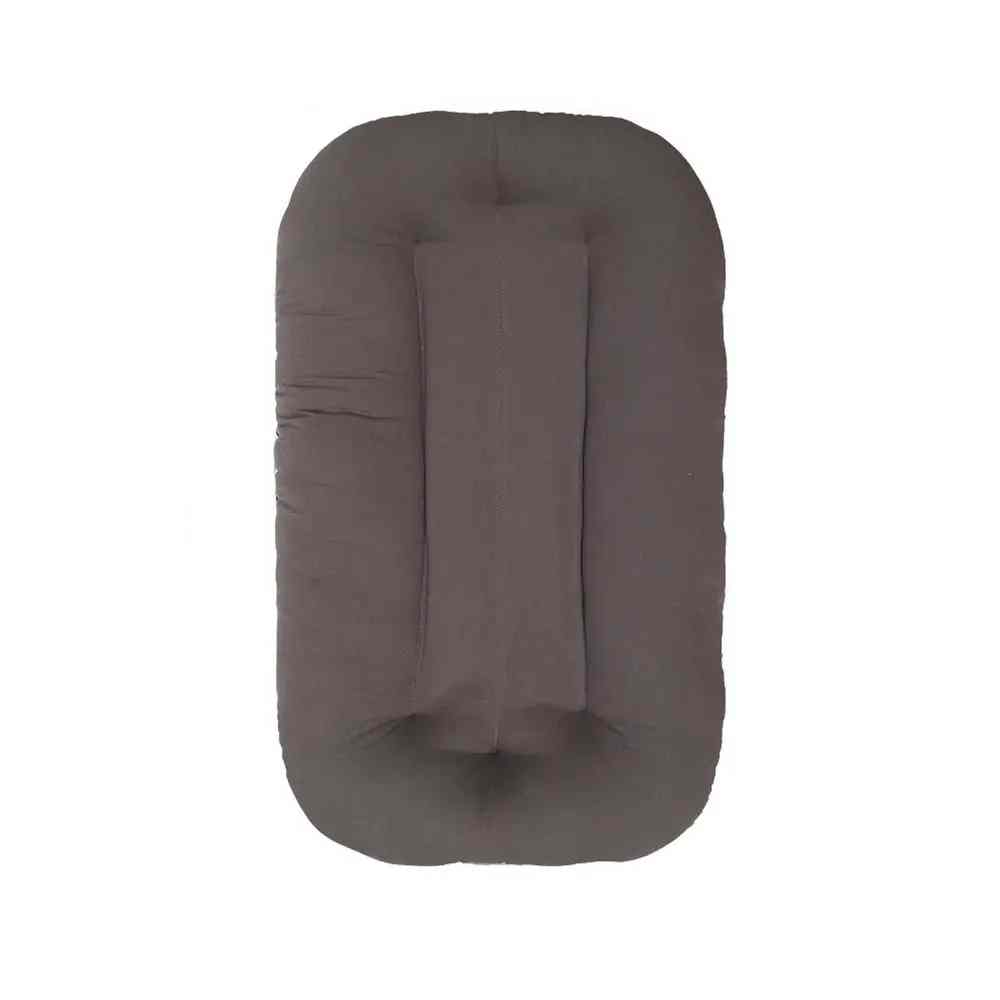 Cozy baby sleeping nest bed lounger for newborns, a comfortable portable baby bed.