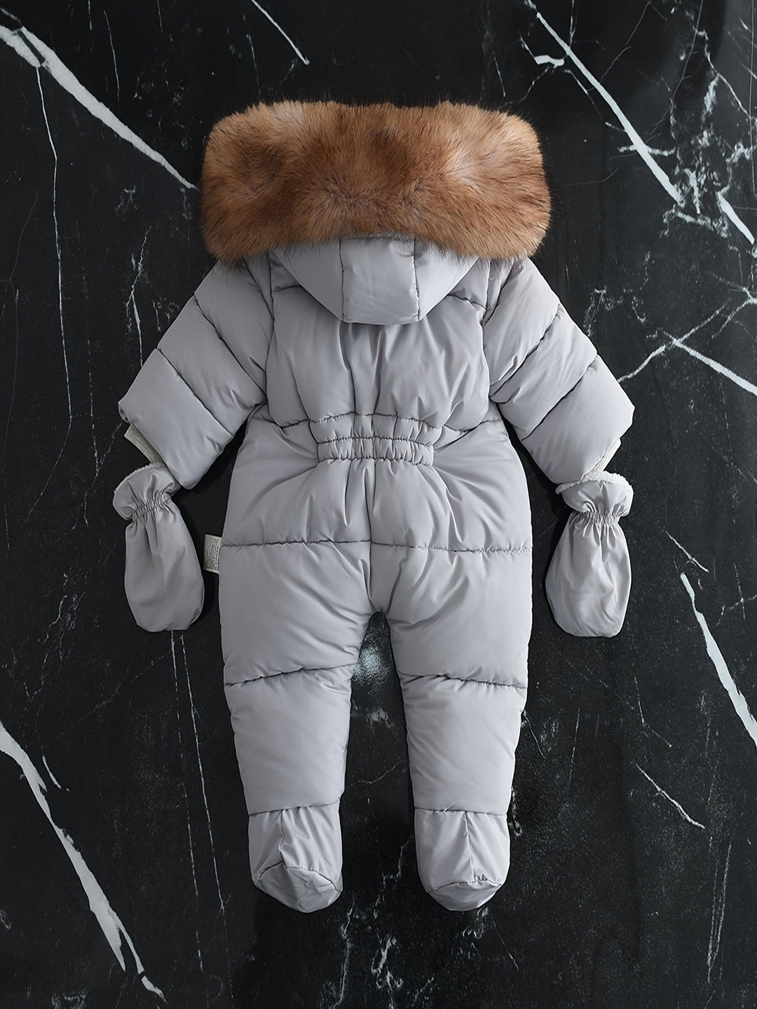 Baby fashion: stylish winter jumpsuit with hood.