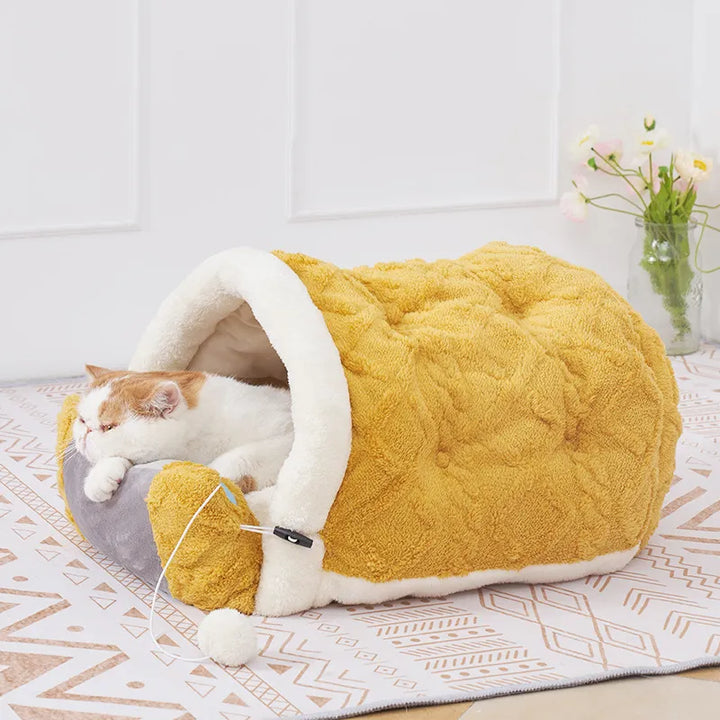 Cozy cat bed cushion with integrated toy for feline comfort and play.