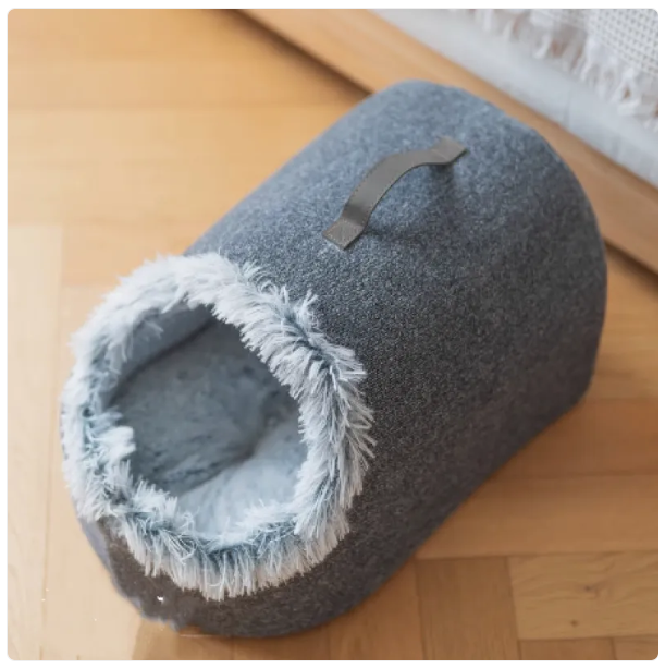 Fluffy-edged plush cat bed, an ultra-soft pet house for cozy feline napping.