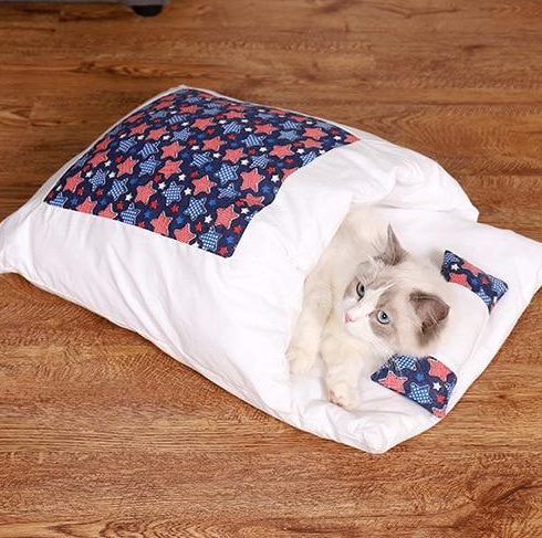 Washable grey cat sleeping bag, a comfortable pet bed for deep feline relaxation & warmth.