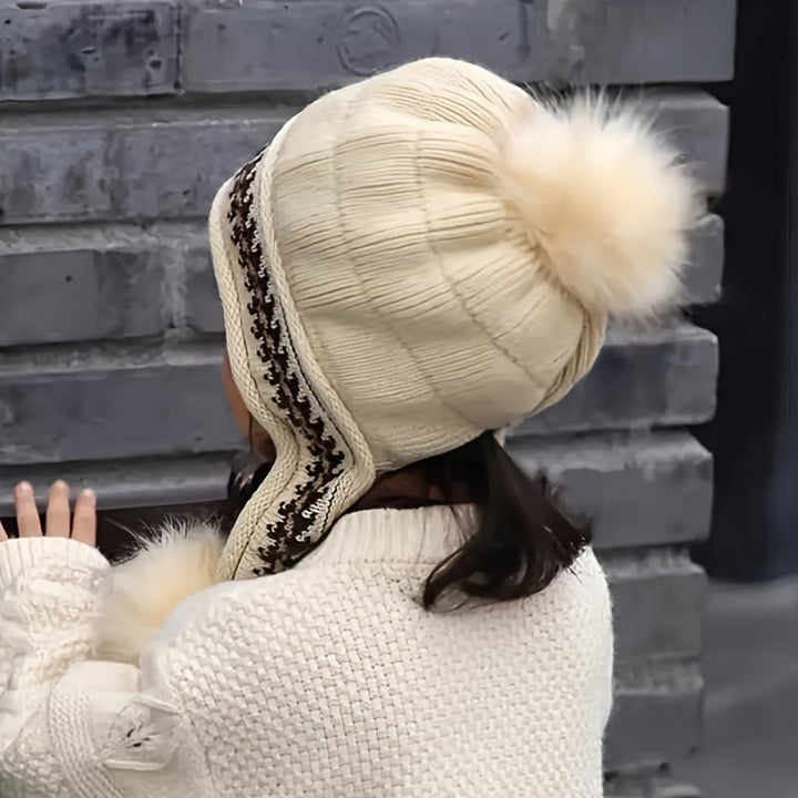 Pink knit kids' cold weather hat. Ear flaps & pom-pom add warmth & a touch of style.