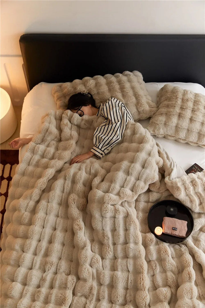 Cozy plush bubble fleece blanket in a soft beige color