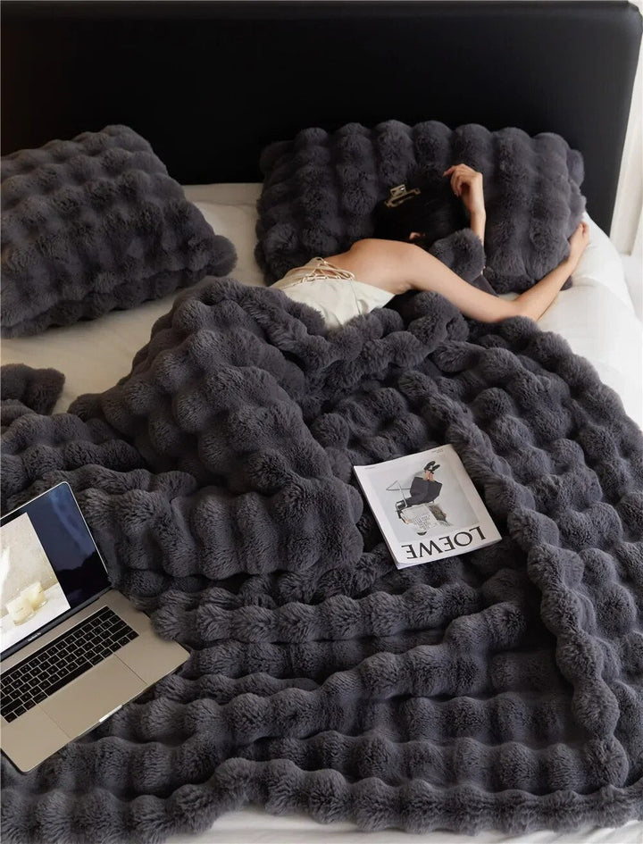 Close-up of the plush bubble texture on a warm fleece throw blanket