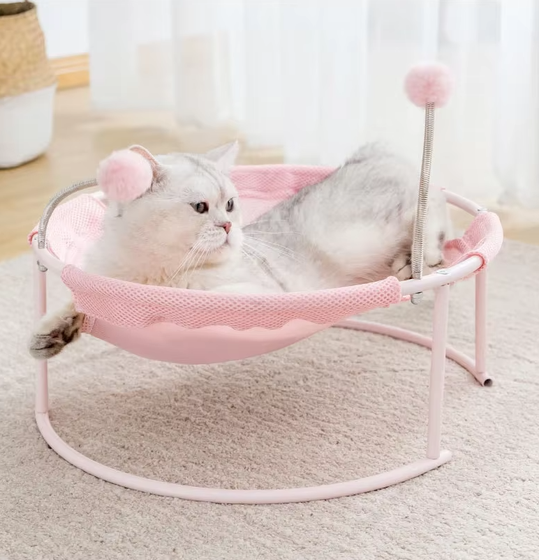 Rosa cat bed hammock, a comfortable & sturdy cat furniture piece with interactive toys.