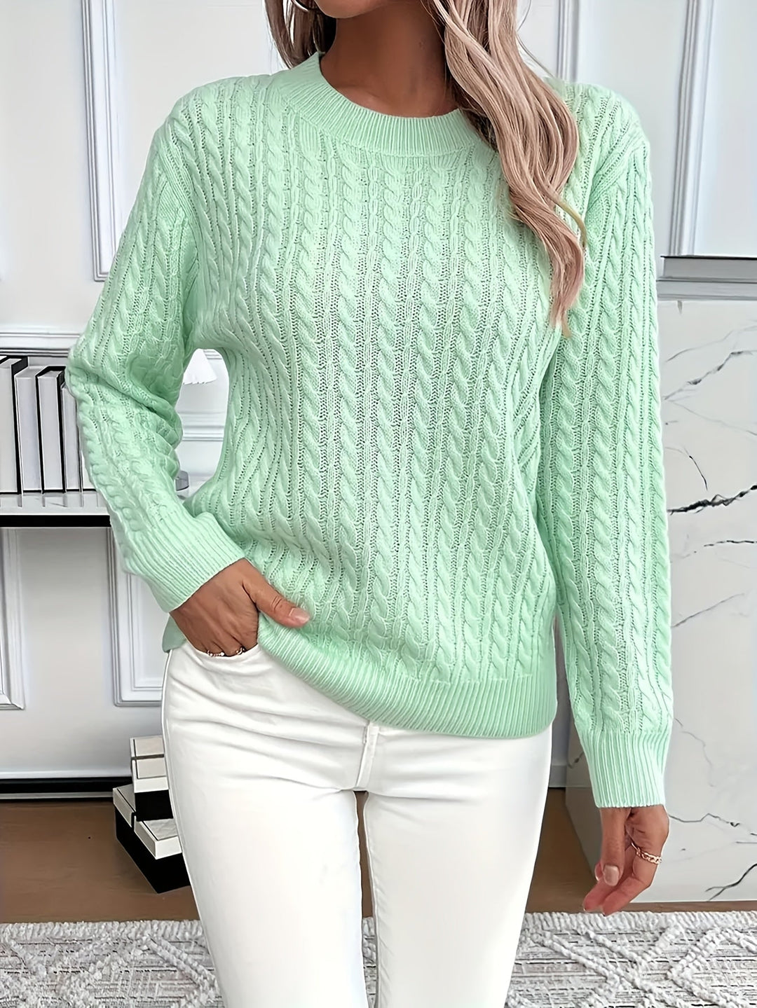 Cozy women's cable knit sweater in a soft blend, perfect for spring or autumn.